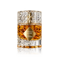 Angels' Share Kitan cologne bottle with a textured clear glass body, amber liquid inside, and a gold diamond-shaped label on a white background with a soft reflection.